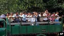 Myanmar prisoners ride a truck as they were released from Insein prison Tuesday, Oct. 7, 2014.