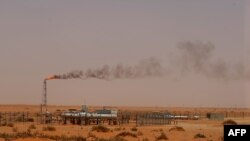 FILE - A Saudi Aramco oil installation known as "Pump 3" in the desert near the oil-rich area of Khouris, 160 km east of the Saudi capital Riyadh, June 23, 2008.