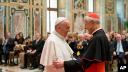 Paus Fransiskus (kiri) berbicara dengan Ketua Yayasan Kepausan Kardinal Donald Wuerl, Uskup Agung Washington D.C., dalam pertemuan dengan anggota yayasan di Vatikan, 17 April 2015.