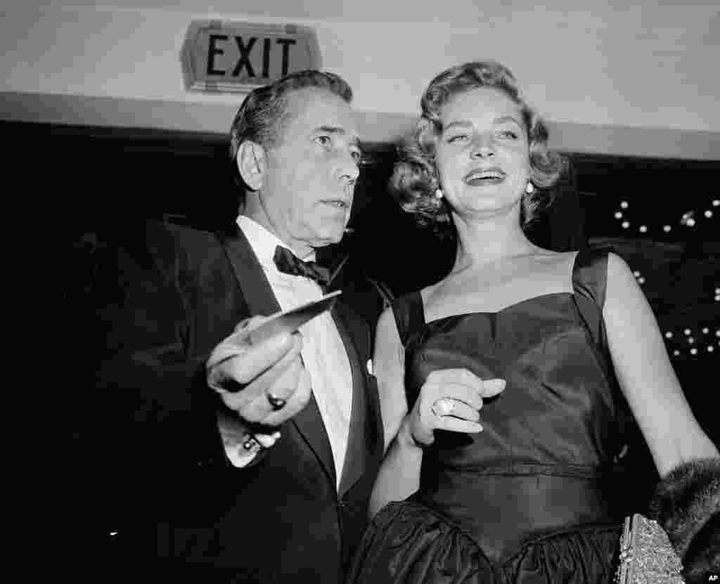 Humphrey Bogart arrives with his wife, Lauren Bacall, for the Hollywood premiere 'The Desperate Hours', Oct. 12, 1955. 