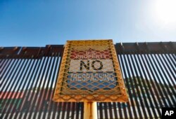 The international border cuts through Nogales, Sonora, Mexico, rear, and Nogales, Arizona, as seen April 9, 2018, from Nogales.