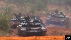 Russian tanks advance during the Zapad 2017 military exercises near St. Petersburg, Russia, Sept. 18, 2017.