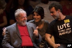 Brazil's former President Luiz Inacio Lula da Silva, left, talks to Manuela D'Avila of Brazil's Communist Party and Rio state Congressman Marcelo Freixo during his presidential campaign rally with members of his Workers Party and leaders of other left-win