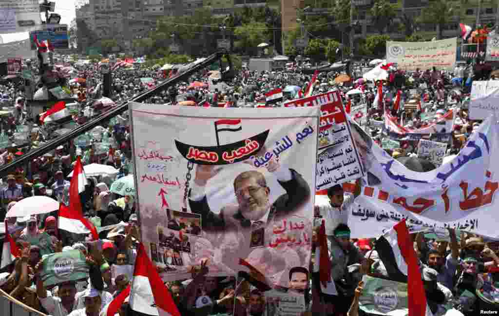 Islamists, members of the brotherhood, and supporters of Egyptian President Mohamed Morsi, shout slogans during a protest around the Raba El-Adwyia mosque square in the suburb of Nasr City, Cairo, June 28, 2013.