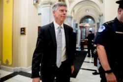 FILE - Former Ambassador William Taylor leaves a closed-door meeting after testifying as part of the House impeachment inquiry into President Donald Trump, on Capitol Hill in Washington, Oct. 22, 2019.