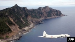 (File) This photo from Oct. 13, 2011, shows Japanese Maritime Self-Defense Force plane flying over the disputed islets known as the Senkaku islands in Japan and Diaoyu islands in China, in the East China Sea.