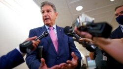 Sen. Joe Manchin, D-W.Va., talks to reporters as he arrives at the Capitol in Washington, Oct. 5, 2021.