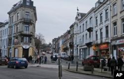 FILE - Belgian police officers guard a street in Verviers, Jan. 16, 2015.
