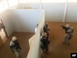 In this photo taken April 13, 2018. Nigerien police who are part of the U.S. Special Program for Embassy Augmentation and Response, known as SPEAR take part in the annual U.S.-led Flintlock exercise in Niamey, Niger.
