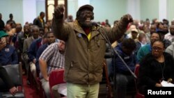 FILE - A man speaks as the Constitutional Review Committee holds public hearings regarding expropriation of land without compensation in Pietermaritzburg, South Africa, July 20, 2018.
