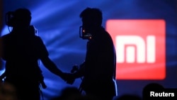 Logo of Xiaomi seen at Xiaomi's tablet launch event, Beijing, May 15, 2014.