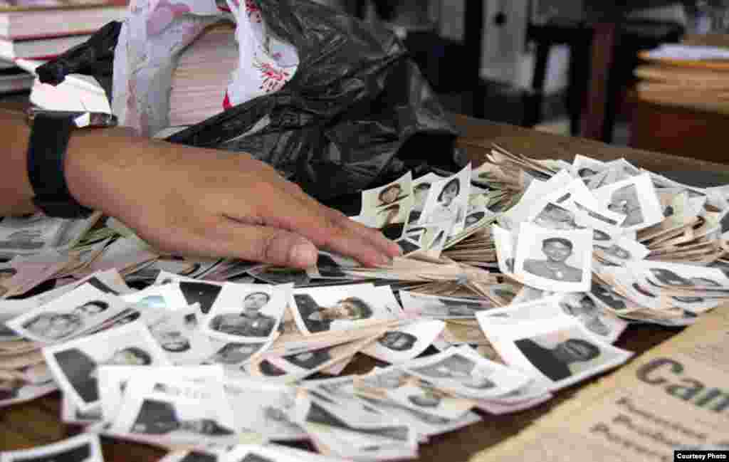A staff member sorts through photographs recently donated to the center. (Credit: DC-Cam)