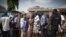FILE - People wait in line to vote at a polling station in Accra, Ghana, Dec. 8, 2012.