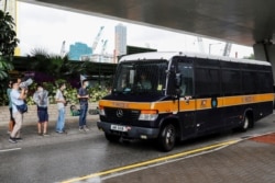 Journalists wait outside West Kowloon Magistrates' Courts in Hong Kong, July 3, 2020.