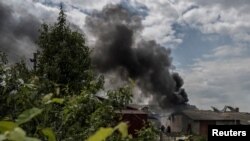 A smoke rises after shelling near the Ukraine-Russia border in the town of Vovchansk