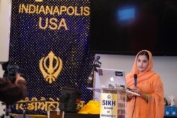 Aasees Kaur, legal client and community services manager of the Sikh Coalition reads a statement to the shooting at a FedEx facility at the Sikh Satsang of Indianapolis, April 17, 2021.