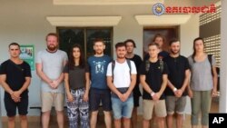 In this file photo dated Jan. 27, 2018, issued by Cambodian National Police, a group of foreigners stand after they were arrested for "dancing pornographically" at a party in Siem Reap town, near the country's famed Angkor Wat temple complex. 
