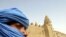 A Tuareg nomad stands near the 13th century mosque at Timbuktu, Mali (file photo).