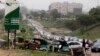 FILE - Cars line up to buy fuel at a petrol station in Abuja, Nigeria, Friday, April 1, 2016. Nigerian labor and civil society groups say their strike planned for Wednesday against a hike in fuel prices will go on as scheduled.