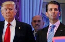 FILE - This Jan. 11, 2017, photo shows President-elect Donald Trump, left, his chief financial officer Allen Weisselberg, center, and his son Donald Trump Jr. during a news conference at Trump Tower in New York.