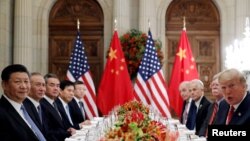 FILE - U.S. President Donald Trump, U.S. Secretary of State Mike Pompeo, U.S. President Donald Trump's national security adviser John Bolton and Chinese President Xi Jinping attend a working dinner after the G-20 leaders' summit in Buenos Aires, Argentina, Dec. 1, 2018. 