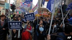 Pro-independence demonstrators march during an annual New Year protest in Hong Kong, Tuesday, Jan. 1, 2019. (AP Photo/Kin Cheung)