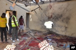 FILE - People inspect a damaged mosque following an explosion in Maiduguri, Nigeria, Oct. 23, 2015. Boko Haram is suspected to be behind that bombing.