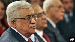 Palestinian President Mahmoud Abbas, left, attends the midnight Mass ceremony at the Church of the Nativity in the West Bank town of Bethlehem, 25 Dec 2010