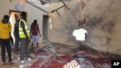 People inspect a damaged mosque following an explosion in Maiduguri, Nigeria, Oct. 23, 2015. Boko Haram is suspected to be behind bombing.