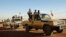 FILE - Soldiers from the Tuareg rebel group MNLA drive in a convoy of pickup trucks in the northeastern town of Kidal, Mali, February 4, 2013. 
