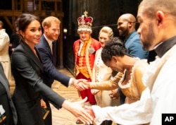 Prince Harry and Duchess Meghan Markle of Sussex pictured after the performance meeting cast and crew backstage at the Victoria Palace Theatre, London.