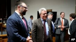 Scott Gessler, center, attorney for former President Donald Trump, talks with team members after closing arguments in a hearing for a lawsuit to keep former President Donald Trump off the state ballot in court, Nov. 15, 2023, in Denver.