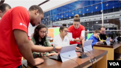 Students learning computer programming skills at a Microsoft store in New York City.