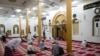 Myanmar Muslims pray after breaking their fast at a mosque during the holy month of Ramadan