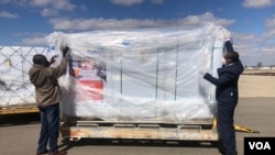 Zimbabwe officials inspect one million SINOVAC vaccines it bought from China on July 25, 2021 in Harare. (VOA/Columbus Mavhunga)