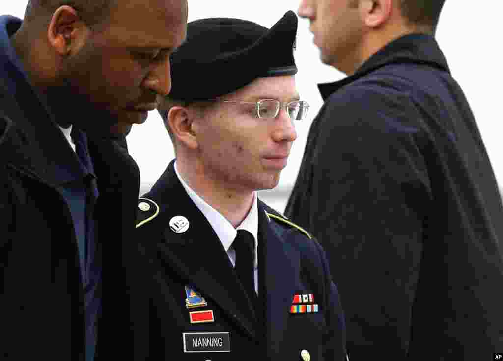 Bradley Manning, center, is escorted into a courthouse in Fort Meade, May 21, 2013, before a pre-trial military hearing. 