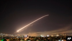 Missile fire lights up the Damascus sky, April 14, 2018.