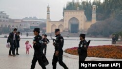 CHINA -- Uighur security personnel patrol near the Id Kah Mosque in Kashgar in western China's Xinjiang region, November 4, 2017.