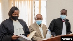 Pahlawan "Hotel Rwanda" Paul Rusesabagina (tengah) muncul bersama pengacaranya David Rugaza (kanan) dan Emeline Nyembo (kiri) di pengadilan Dasar Kicukiro di Kigali, Rwanda, pada 14 September 2020. (Foto: Reuters)
