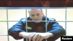 FILE - Russian opposition leader Alexei Navalny is seen on a screen via a video link from the IK-2 corrective penal colony in Pokrov during a court hearing to consider an appeal against his prison sentence in Moscow, Russia May 24, 2022. 