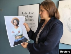 H&M Foundation Global Manager Diana Amini poses with portraits of women on its Foundation 500 list of female entrepreneurs in emerging markets in Stockholm, Sweden, June 2, 2017.