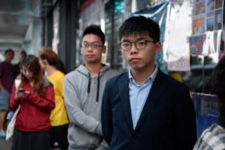 Disqualified candidate and pro-democracy activist Joshua Wong stands in line to vote in the district council elections in Hong Kong, Nov. 24, 2019.