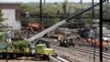 Workers labor at the site of Tuesday's derailment of an Amtrak Northeast Regional train in Philadelphia, May 15, 2015.