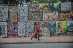 FILE - A woman walks in a deserted street in Port-au-Prince on Oct. 18, 2021.