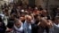Christian worshipers carry a cross towards the Church of the Holy Sepulcher, traditionally believed by many to be the site of the crucifixion of Jesus Christ, during the Good Friday procession in Jerusalem's Old City, Mar. 29, 2013. 