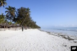 A villager walks along a deserted beach near a seaside resort on the East African archipelago of Zanzibar, Oct. 12, 2010.