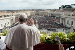 Pope Francis acknowledges pilgrims while delivering the Urbi et Orbi blessing at the end of the Easter Sunday Mass in St. Peter's Square at the Vatican, April 1, 2018.