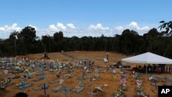 FILE - New graves fill the Nossa Senhora Aparecida cemetery, in Manaus, Amazonas state, Brazil, April 21, 2020. 