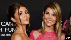 In this Feb. 28, 2019 file photo, actress Lori Loughlin poses with her daughter Olivia Jade Giannulli, left, at the 2019 "An Unforgettable Evening" in Beverly Hills, Calif. 