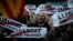 Demonstrators gather during a protest calling for the release of Catalan jailed politicians, in Barcelona, Spain, Nov. 11, 2017. Eight members of the now-defunct Catalan government remain jailed in an alleged rebellion case. The banners read in Catalan: "Freedom for the political prisoners."